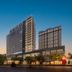 Haobo International Hotel in Wuxi at dusk with modern high-rise tower and lit facade