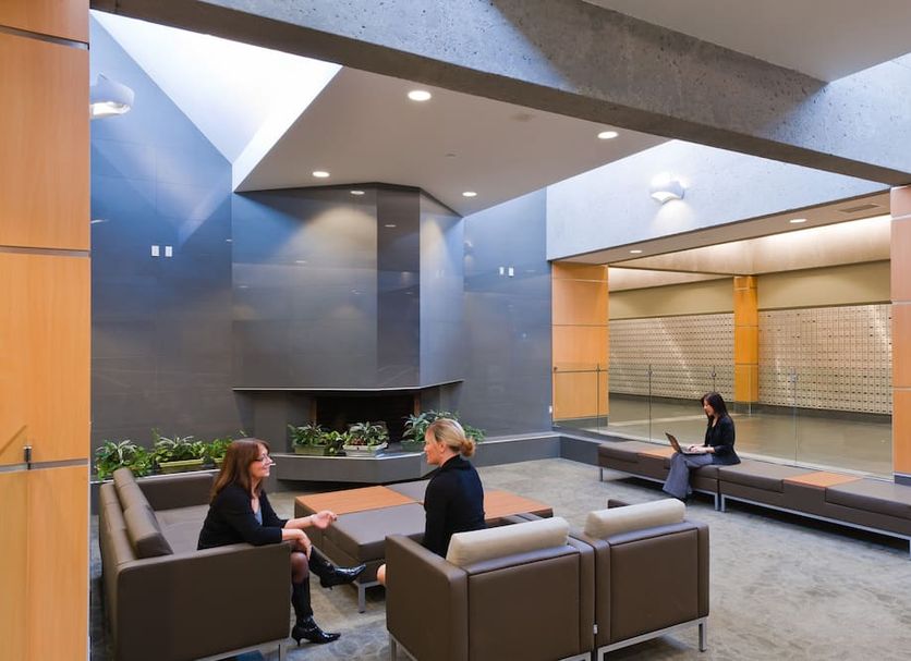 West Coast Suites At Ubc in Vancouver lobby seating area with fireplace and lounge chairs