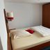 Weserlounge Hotel Garni in Hessisch Oldendorf guest room with double bed, wardrobe, and window