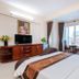 Queen Garden Hotel & Apartment in Vung Tau guest room with bed, TV, desk and window seating