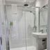 OYO The Leven in Felixstowe bathroom with walk-in shower, pedestal sink and toilet