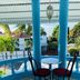 Villa Antonia 16 in Sosúa: balcony with table and chairs overlooking a pool and tropical trees