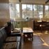 Sudha's Garden Home Kathmandu lobby with seating, table, large windows and staircase