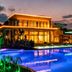 Kaya Palazzo Golf Resort in Belek with illuminated pool and modern resort building at dusk