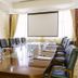 Boma Inn Nairobi in Nairobi conference room with oval table, black chairs, projector screen and water bottles