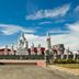 Kenyalang Suite, Miri: outdoor courtyard with multiple white statues and blue sky