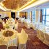 Shenyang Neu International Hotel in Shenyang banquet hall with round tables, white chair covers and large windows