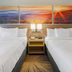 Days Inn Roanoke Near I-81 room with two double beds and sunrise wall art in Roanoke