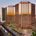 Embassy Suites by Hilton Phoenix Downtown North towers over Phoenix skyline at sunset with palm-lined streets