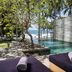 Kelapa Retreat & Spa in Pekutatan with a tropical pool, ocean view, and palm trees