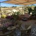 Anitya Cave House in Ürgüp terrace with seating, flowers, canopy and hillside view