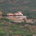 Kadambavanam Ethnic Village Resort in Madurai on a hillside surrounded by lush green hills