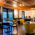 Hotel Mountain Brook in Tannersville lounge with seating, tables, wood ceiling and balcony doors