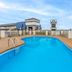 Days Inn by Wyndham Harrisonburg outdoor pool with lounge chairs and fenced deck in Harrisonburg