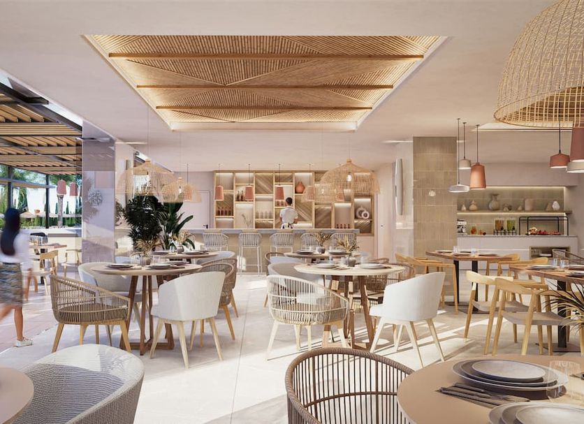 Bordoy Alcudia Bay dining area in Alcúdia with bright tables, woven chairs and open buffet display