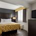 Baymont by Wyndham Branford/New Haven guest room with king bed, TV, and window in Branford