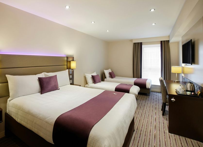 Premier Inn Norwich East - Broadlands/A47 bedroom with two beds, desk and window light in Norwich