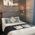 The White Swan Leeds guest room with double bed, geometric wall paneling and bedside lamps