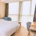 Home Inn Neo Wuxi Xihu East Road Dongting guest room with bed, desk and large window in Wuxi