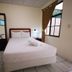 Hotel Armonía Hostal room in San Salvador with double bed, wardrobe, desk and window