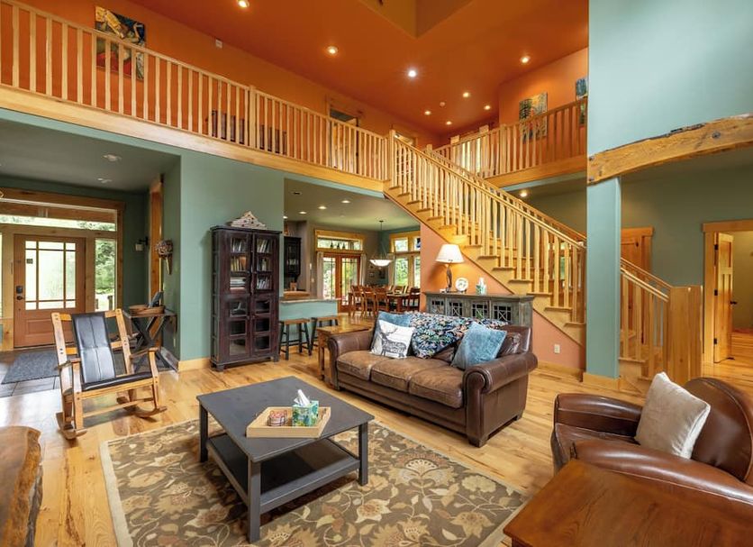 Copper Creek Inn, Cabins and Lodge in Ashford: spacious lodge lounge with staircase, leather seating and loft