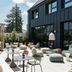 Hotel Schani Uno City Vienna courtyard terrace with outdoor seating and planters beside a modern black facade