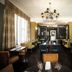 Steventon House Hotel in Abingdon dining room with chandeliers, dark walls and set tables
