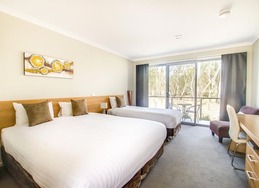 Campaspe Lodge Echuca guest room with two beds and balcony door overlooking trees