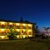 Hotel La Playa Blanca in Santo Stefano di Camastra, lit beachfront hotel with ocean view at dusk
