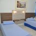 Hotel Blue Star II room in Foz do Iguaçu with two twin beds and blue window blinds