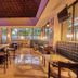 Bahia Principe Grand Coba in Akumal dining area with high ceiling, tables, chairs and bright windows