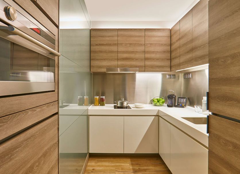 Pan Pacific Serviced Suites Beach Road, Singapore kitchen with wood cabinets and white countertops