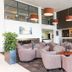 Heartland Hotel Auckland Airport lobby lounge in Mangere with plush seating and hanging pendant lights