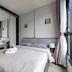 Many Holiday The Base Condo Pattaya bedroom with bed, mirrored wardrobe and window view