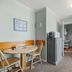 Echo Motel in Old Orchard Beach guest room with table, chairs, kitchenette, mini fridge and window