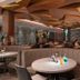 Henann Tawala Resort in Panglao: stylish lounge with curved banquette seating, round tables and floral decor