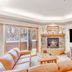 Canyon Creek, Steamboat Springs living room with fireplace, TV, sofa and balcony door
