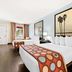 Super 8 by Wyndham Florida City/Gateway to Keys/Everglades guest room with two beds and palm artwork