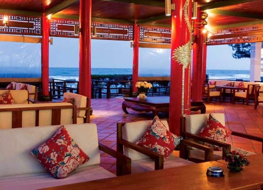 Full Moon Village Resort in Mũi Né with open-air lounge seating and ocean views at sunset