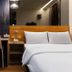 Check Inn Express Taichung Fuxing Hall 2 guest room with bed, desk and chair in Taichung City