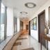 Fabhotel Emerald, Ranchi: modern hotel corridor with framed art, console table, and curved window wall