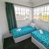 Kiwi's Nest Budget Accommodation & Backpackers in Dunedin twin room with two single beds and corner windows