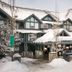 Glacier Lodge in Whistler covered in snow, with chalet-style balconies and mountain lodge exterior