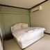 Bangrak Resort in Nakhon Sawan bedroom with king bed, wall mirror and air conditioner