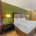 Extended Stay America Suites - Bakersfield - California Avenue room with king bed, window and armchair