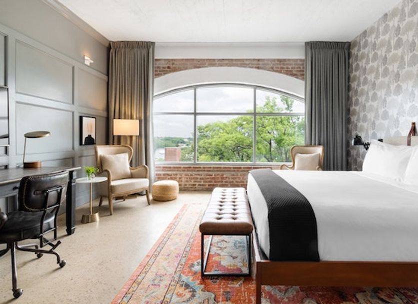 Arrive Memphis guest room with arched window, city view, desk and bed in Memphis
