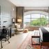 Arrive Memphis guest room with arched window, city view, desk and bed in Memphis