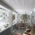 Mountain Meadows Inn & Chalet Suites in Ashford: covered porch with seating and snowy wooded view