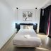 AYZ Javier Cabrini in Madrid: compact guest room with double bed, wall art, and dark curtains