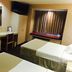 Microtel Inn & Suites by Wyndham Baldwinsville/Syracuse room with two beds, desk, TV, and window seat